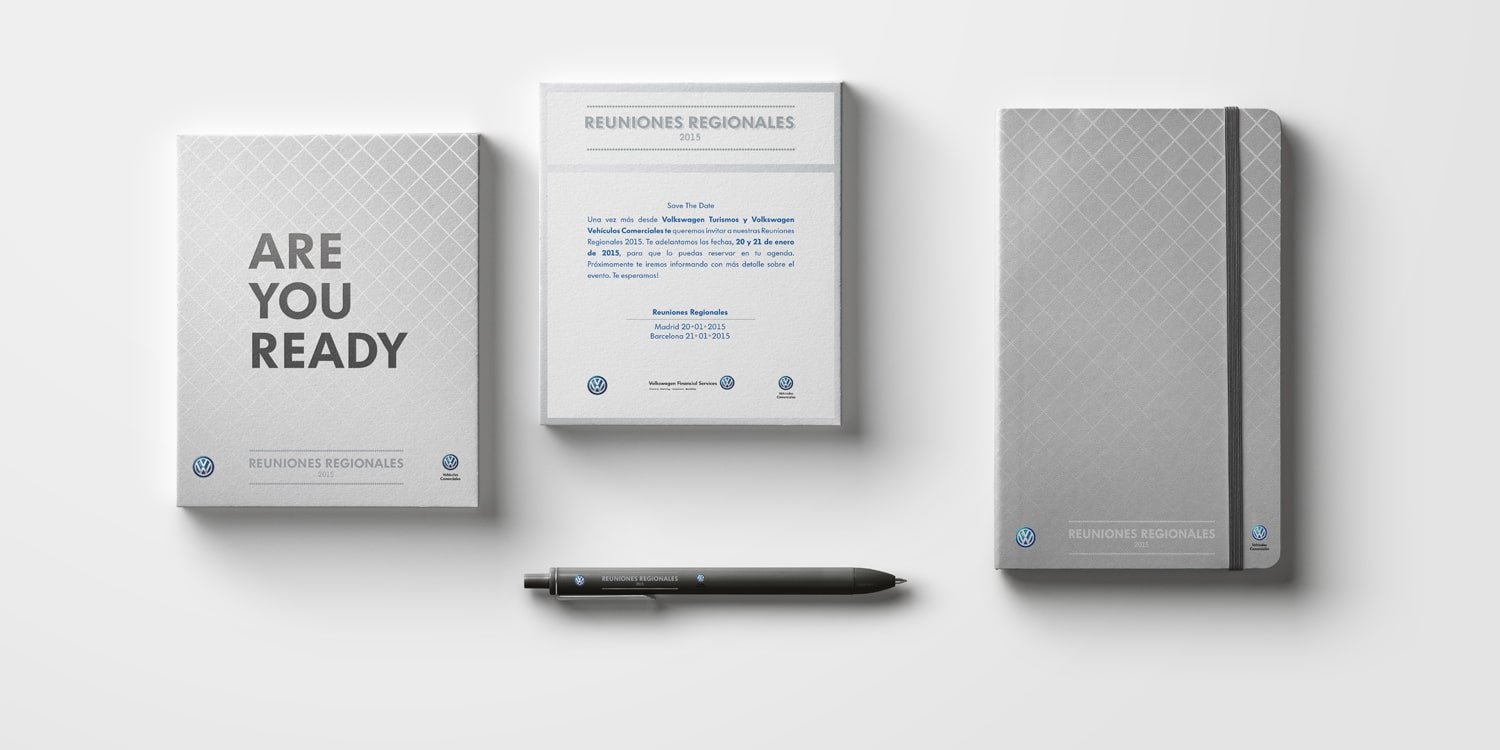 mockup of the volkswagen regional conference materials. A pamplet, a plaque, and a notebook with a pen underneath