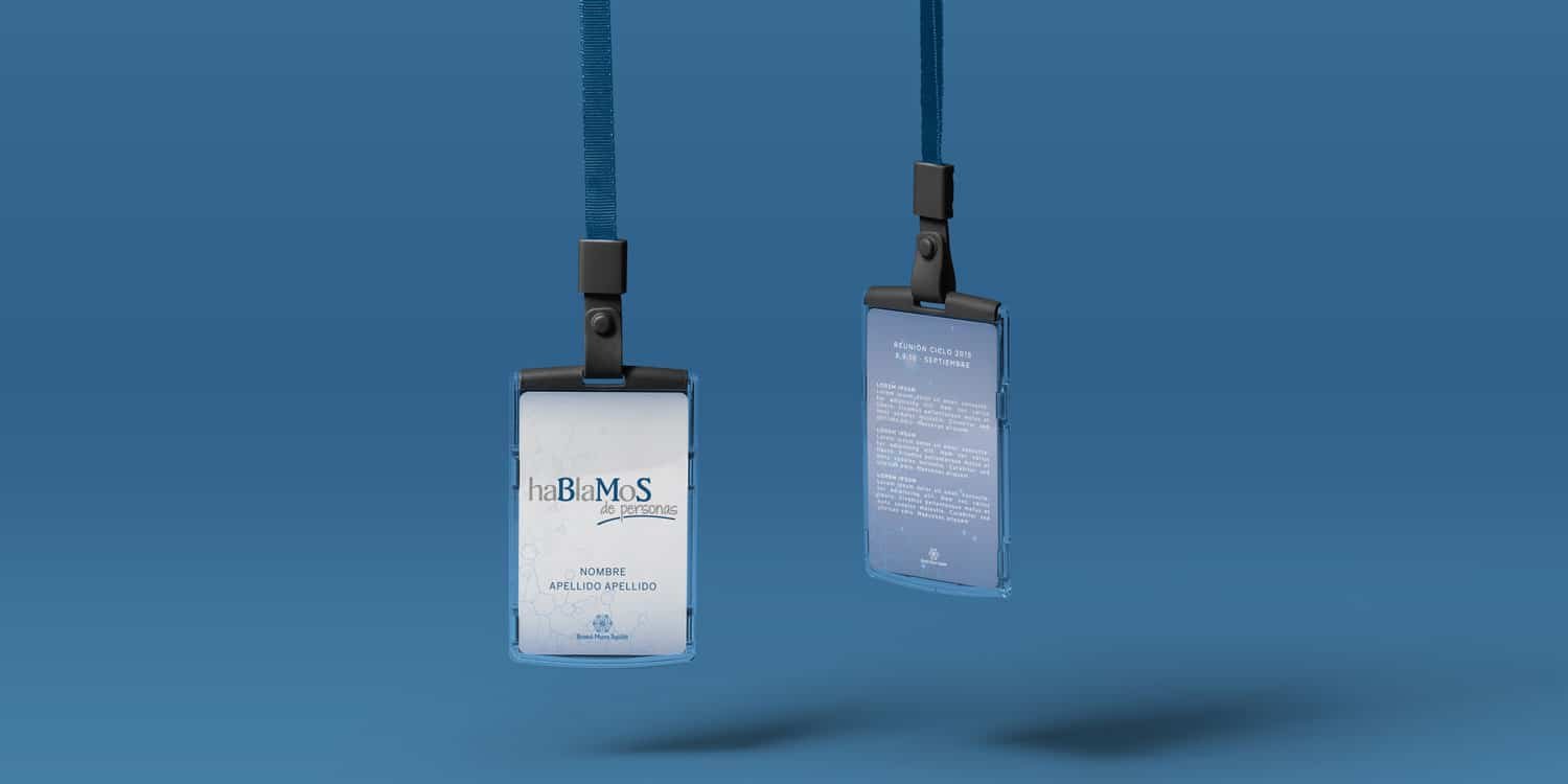 Two Bristol Myers Squibb conference badges with blue lanyards, a white campaign-branded front and a blue programme reverse.