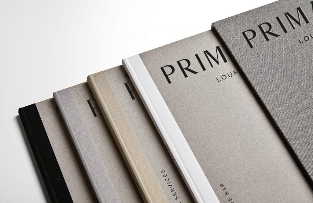 Prima Vista, a stack of menues with textured covers.