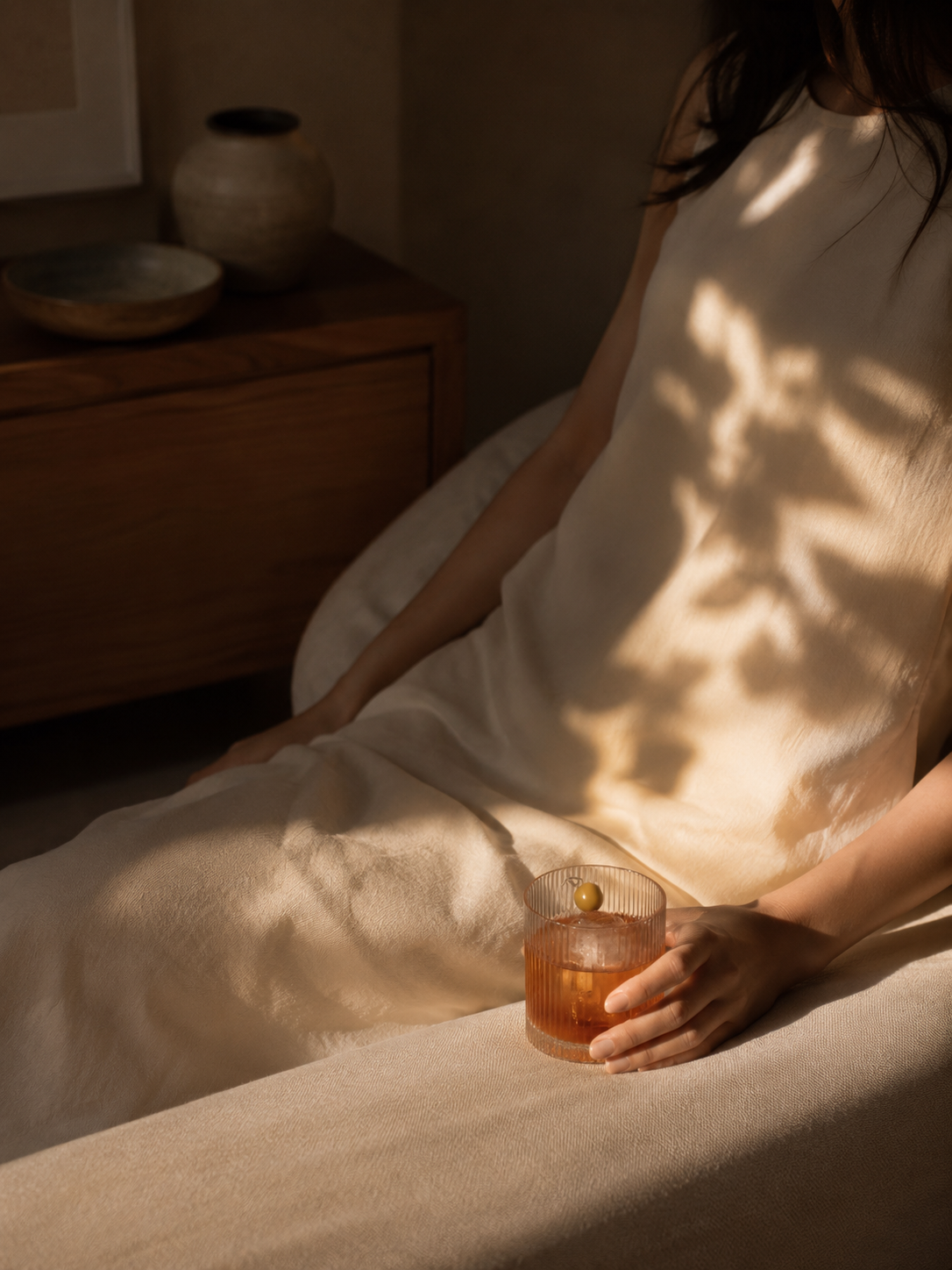 Guest relaxing in a Mediterranean hotel room with warm natural light
