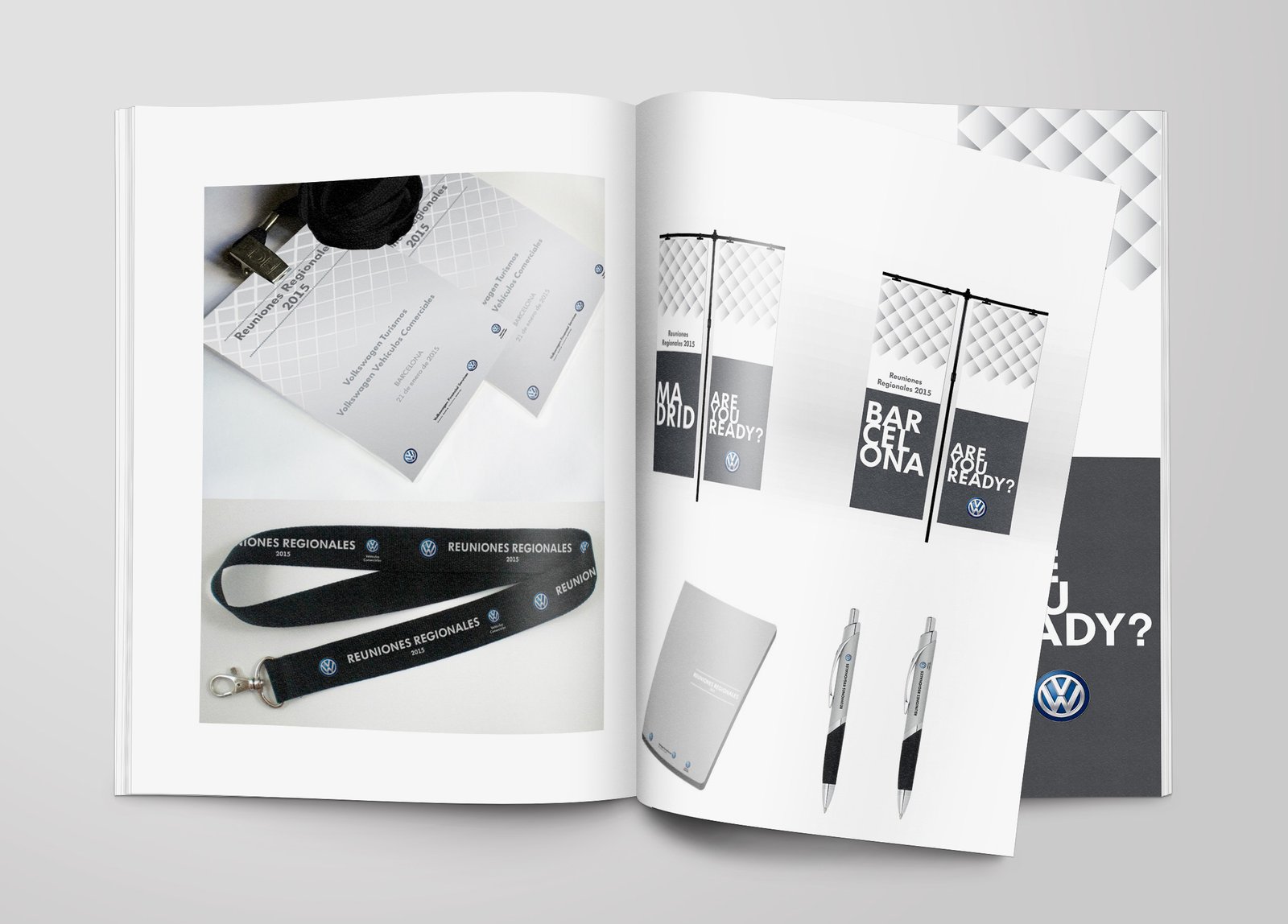 Open Volkswagen event design booklet showing badges, lanyards, flags, pens, notebooks and grey geometric banner graphics.