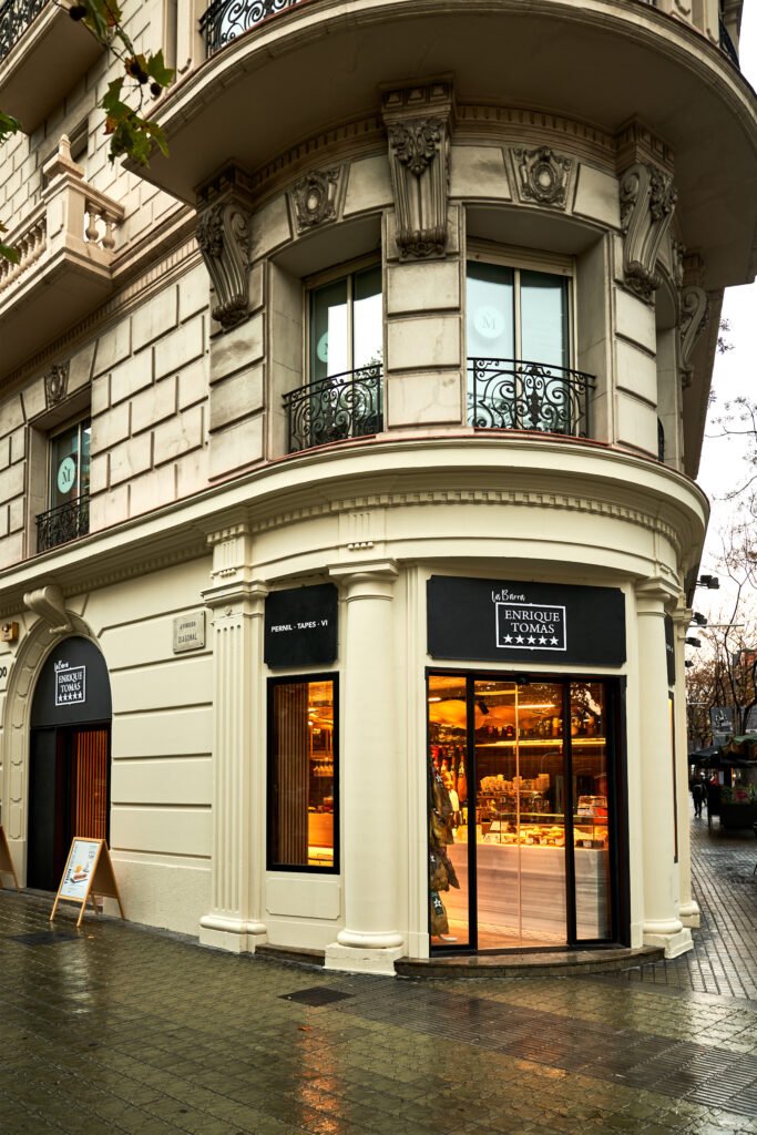 Exterior view of Enrique Tomás store in Barcelona, showcasing its welcoming entrance and elegant design.
