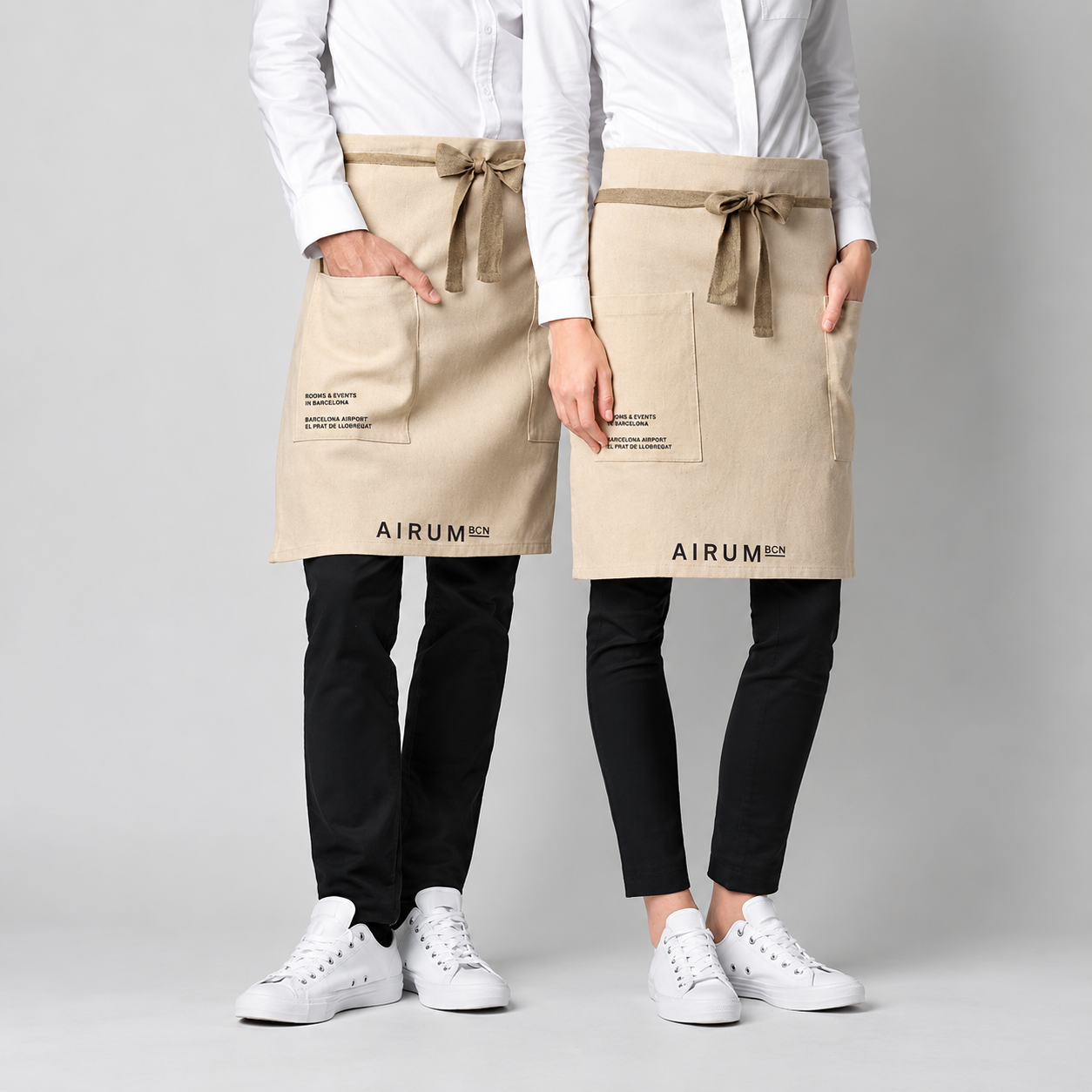 AIRUM hospitality staff uniforms with branded beige aprons by Indy Blue Studio